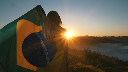 Brazilian Girl with National Flag at sunrise - obrazy, fototapety, plakaty