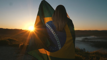 Brazilian Girl with National Flag at sunrise - obrazy, fototapety, plakaty