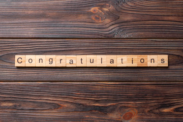 congratulations word written on wood block. congratulations text on wooden table for your desing,...