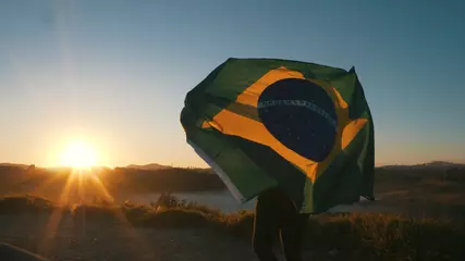 Fotobehang Brazilian Girl with National Flag at sunrise © Marcelo
