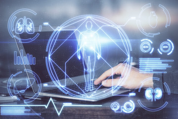 Science hologram with man working on computer on background. Concept of study. Double exposure.