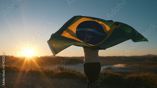 Brazilian Girl with National Flag at sunrise