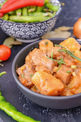 Frying pan with tasty beef stew on table, closeup