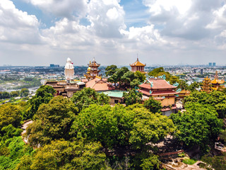 Aerial view of bodhisattva architecture and double sky dragon in Chau Thoi pagoda, Binh Duong province, Vietnam in the afternoon with sun through cloud create auspicious buddha.