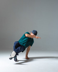 Cool guy breakdancer dancing lower break dance isolated on gray background. Breakdance poster