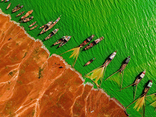 Aerial view of Ben Nom fishing village, a brilliant, fresh, green image of the green algae season...