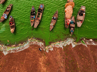 Aerial view of Ben Nom fishing village, a brilliant, fresh, green image of the green algae season...