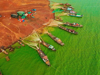 Aerial view of Ben Nom fishing village, a brilliant, fresh, green image of the green algae season...