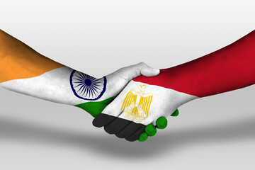Handshake between egypt and india flags painted on hands, illustration with clipping path.