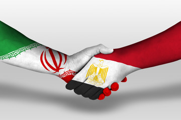 Handshake between egypt and iran flags painted on hands, illustration with clipping path.