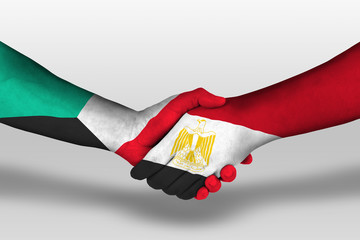 Handshake between egypt and kuwait flags painted on hands, illustration with clipping path.