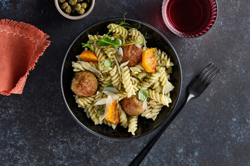 Pasta with meatballs and homemade parsley pesto sauce. Copy space.
