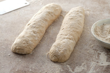 Raw baguette dough with whole grain rye flour. Copy space.