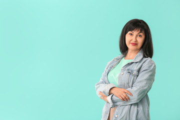 Beautiful mature woman on color background