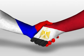 Handshake between egypt and russia flags painted on hands, illustration with clipping path.