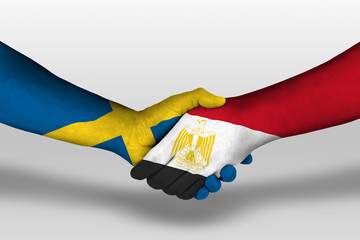 Handshake between egypt and sweden flags painted on hands, illustration with clipping path.