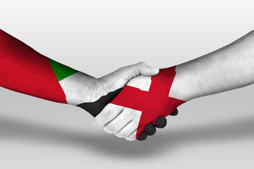 Handshake between england and united arab emirates flags painted on hands, illustration with clipping path.