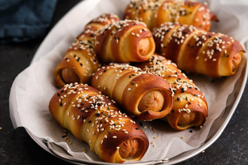 Pretzel dogs with sausages on black background. Oktoberfest.