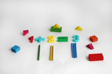 letters, numbers, counting sticks and shapes on a white background