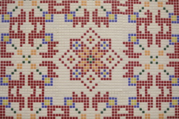 Fototapeta premium Checkered traditional Bulgarian ceramic mosaic tile background pattern. Architectural mosaic detail, abstract background for street, bath and pool. Ornamental pattern for street and interior design