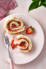 Strawberry jam swiss roll, selective focus. Top view.