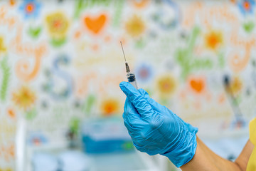 Syringe with medicine in hand for injection. Prevention and health care concept. Close-up