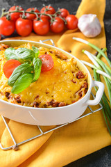 Baking dish with tasty beef casserole on table