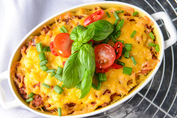 Baking dish with tasty beef casserole on table