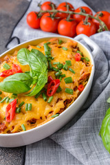 Baking dish with tasty beef casserole on table