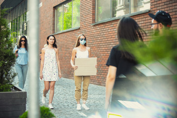 Dude with sign - woman stands protesting things that annoy her. Solo demonstration her right to...