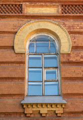 old wooden window in a brick building. red brick wall and wooden window frame.