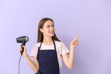 Female hairdresser showing something on color background