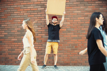 Dude with sign - man stands protesting things that annoy him. Solo demonstration his right to talk...