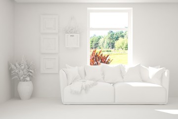 White living room with sofa and summer landscape in window. Scandinavian interior design. 3D illustration