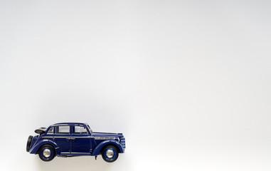 Fototapeta na wymiar Model of a blue vintage children's car on white isolate, place for text