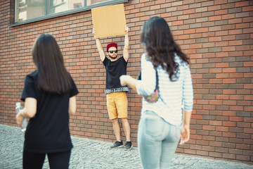 Dude with sign - man stands protesting things that annoy him. Solo demonstration his right to talk...