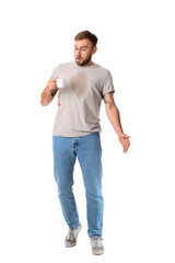 Stressed young man with coffee stains on his t-shirt on white background