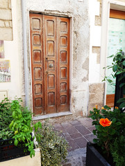 Old vintage wooden front door in an italian city