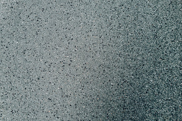 First raindrops on dry asphalt road
