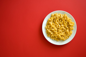 Plate of Macaroni and Cheese on a Red Background