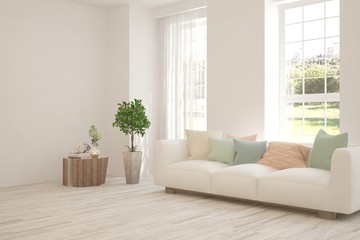 White living room with sofa and summer landscape in window. Scandinavian interior design. 3D illustration