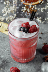 Smoothie made from frozen raspberries, blueberries. Cocktail with blueberries and raspberries on a decorative background