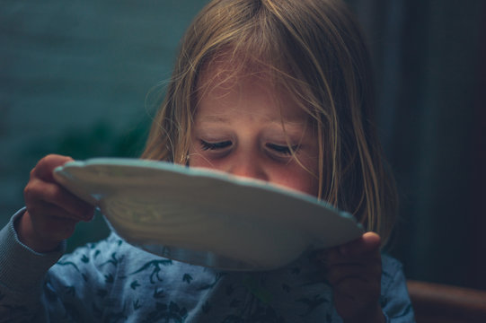 Little Preschooler Licking His Dinner Plate