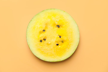 Cut yellow watermelon on color background