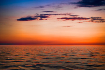 Naklejka na ściany i meble bright sunset over the blue sea