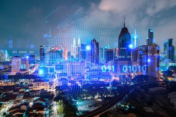 Hologram of Earth planet map on night panoramic cityscape of Kuala Lumpur, Malaysia, Asia. The concept of international companies in KL. Multi Exposure.
