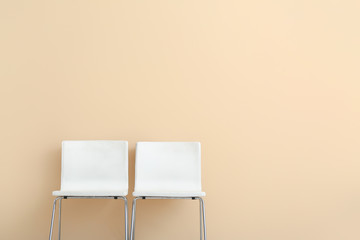 Modern chairs near color wall