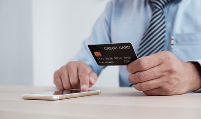 Online payment,Man's hands holding a credit card and using smart phone for online shopping