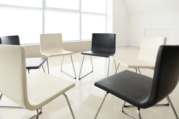 Empty chairs prepared for group therapy in psychologist's office