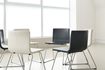 Empty chairs prepared for group therapy in psychologist's office